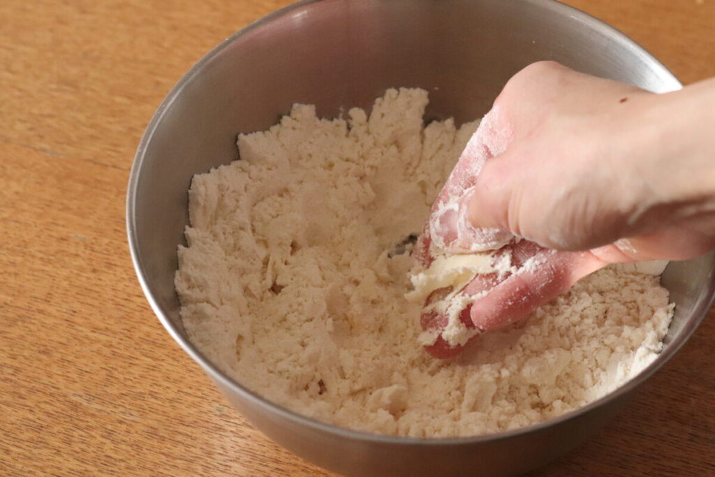 ③バターを入れて、手でバターの塊をすり潰すように粉と合わせる。